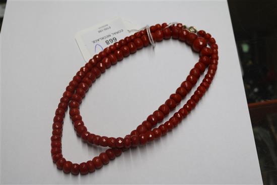A single strand graduated facetted coral bead necklace, 69cm.